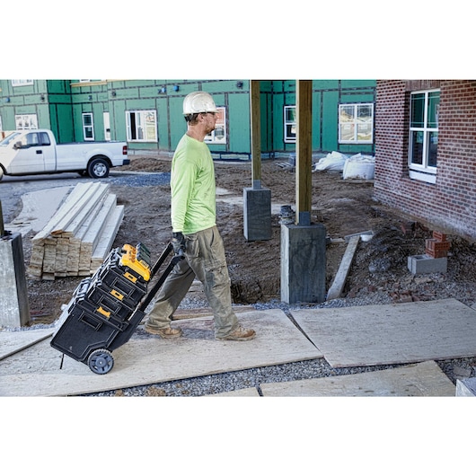 Multiport fast charger being taken to anor workspace by a construction worker