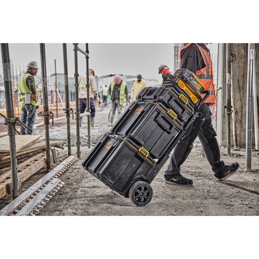 Powershift 554WH battery stacked on top of ToughSystem storage being wheeled across a construction site