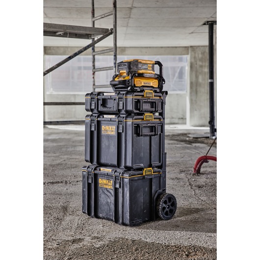 Powershift 554WH battery stacked on top of ToughSystem storage on a construction site