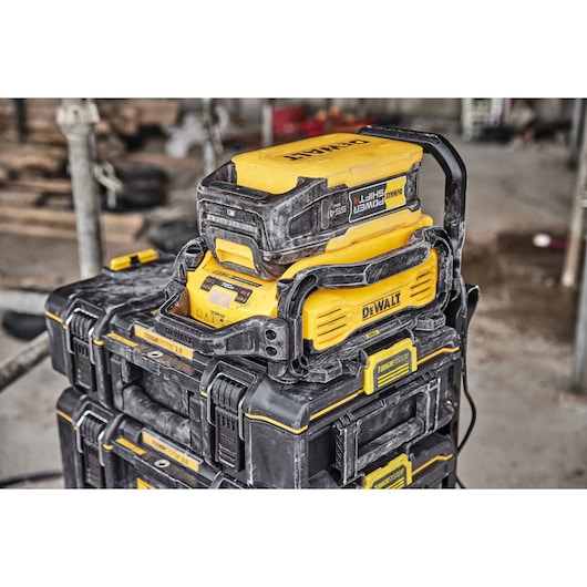 Powershift 554WH battery and Powershift charger DCBPSC0550 stacked on top of ToughSystem storage