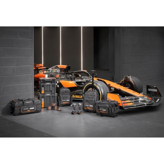 Limited Edition DEWALT/McLaren storage bags, Tstak trolley, impacts and accessory boxes displayed in front of a McLaren racing car