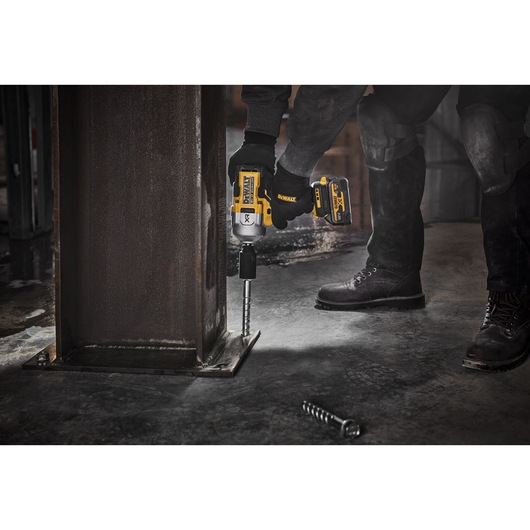 18V XR Brushless 1/2 inch High Torque Impact Wrench with socket, fastening a screwbolt in to a metal base 