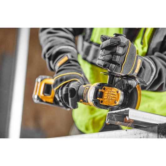 A tradesman using a DCG409VST1 to cut cable tray