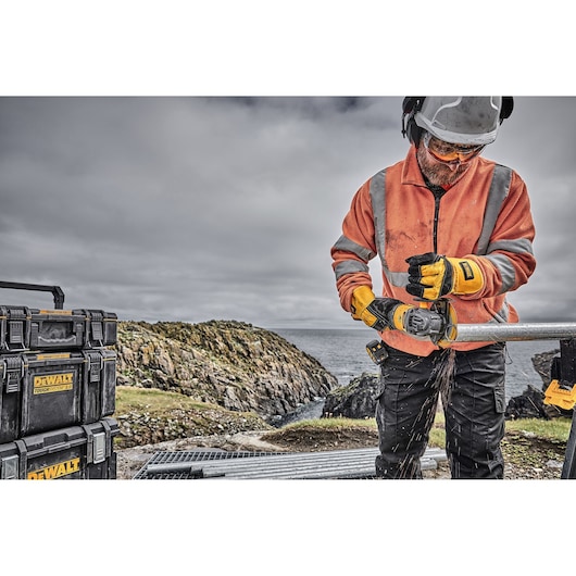 6 INCH CORDLESS GRINDER WITH KICKBACK BRAKE being used by a workman on a snowy work site