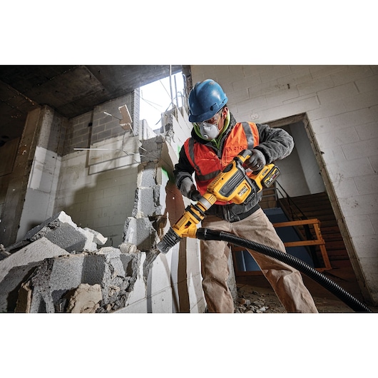 Brushless, cordless SDS MAX combination rotary hammer being used by a person