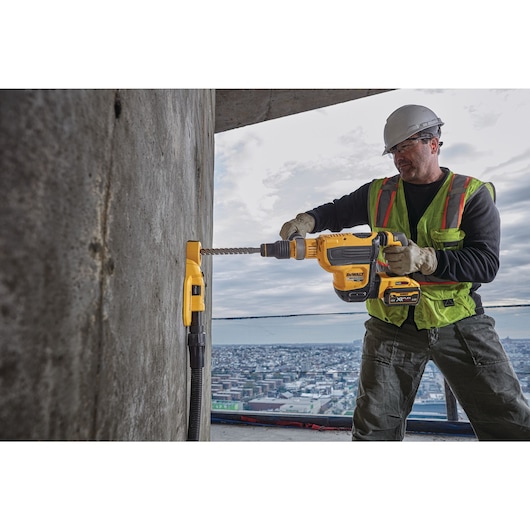 Brushless, cordless SDS MAX combination rotary hammer being used by a person