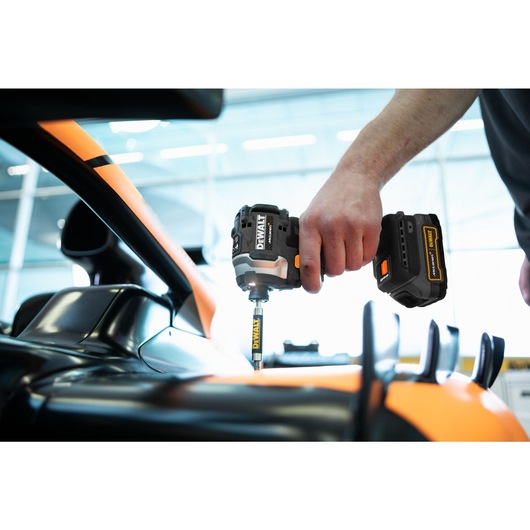 Limited Editon DEWALT/McLaren Impact Driver being used by mechanic on a McLaren car chassis