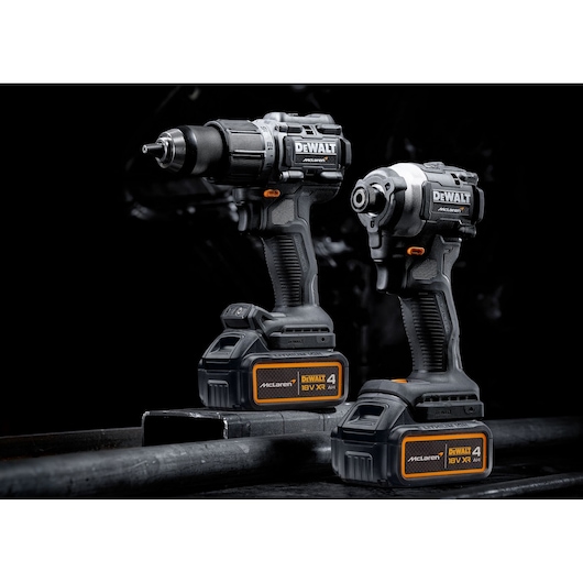 DEWALT/McLaren Drill Driver and Impact Driver with 18V XR 4Ah batteries  3/4 view in staged dark setting