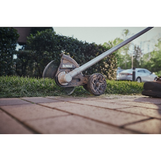 Close view of the DEWALT 54V XR FLEXVOLT Straight Shaft Edger trimming lawn edge