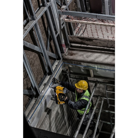 Cordless Concrete Nailer driving nails into steel.