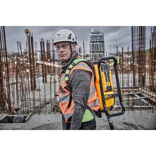 Worker wearing Powershift Backpack Concrete Vibrator on his back