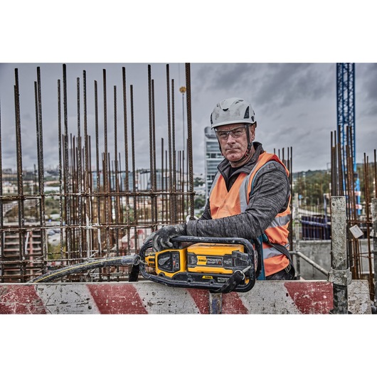 Construction worker holds Powershift Powerpack Concrete Vibrator 