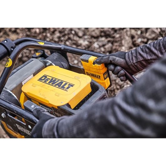 Construction worker presses power switch on Powershift Rammer