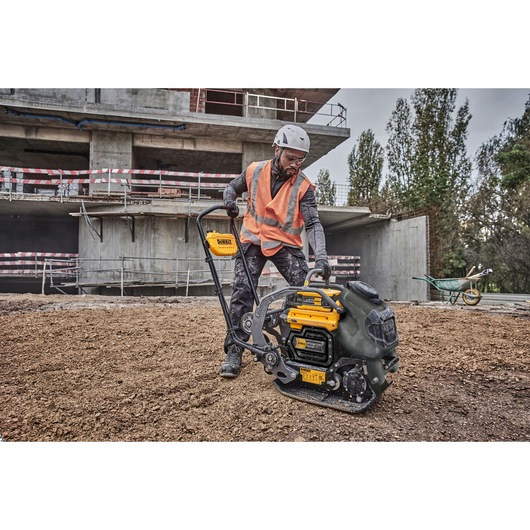 Construction worker preparing to use Powershift Plate Compactor