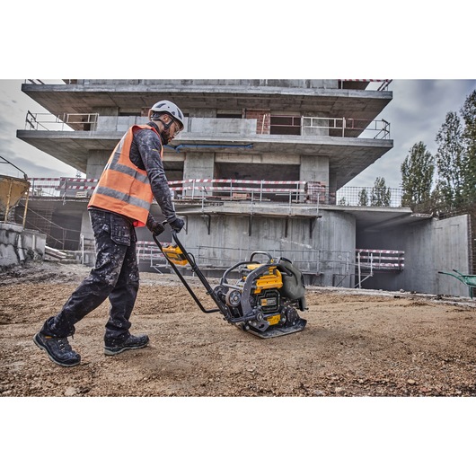 Worker uses Powershift Plate Compactor to compress the ground on a construction site