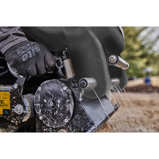 Worker activates the sprinkler system on a Powershift Plate Compactor