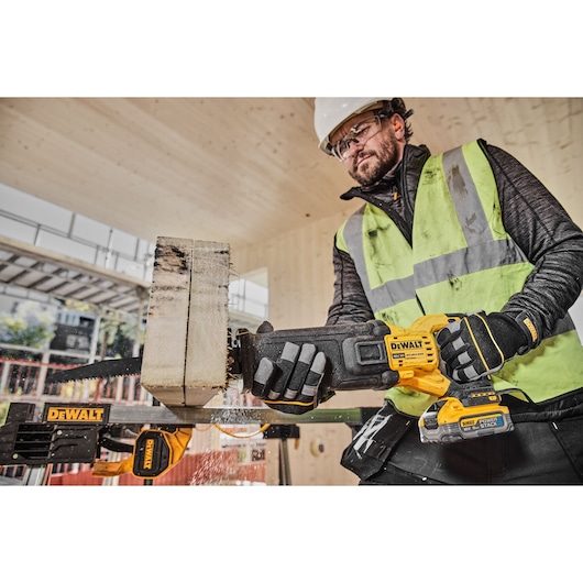18V Brushless reciprocating saw cutting thick wood on work site
