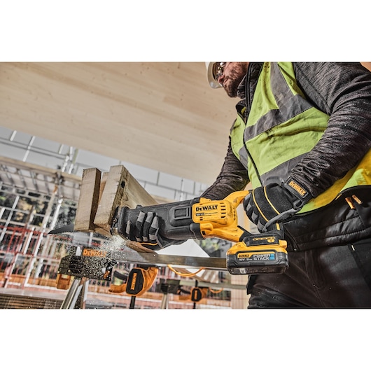 18V Brushless reciprocating saw cutting thick wood on work site