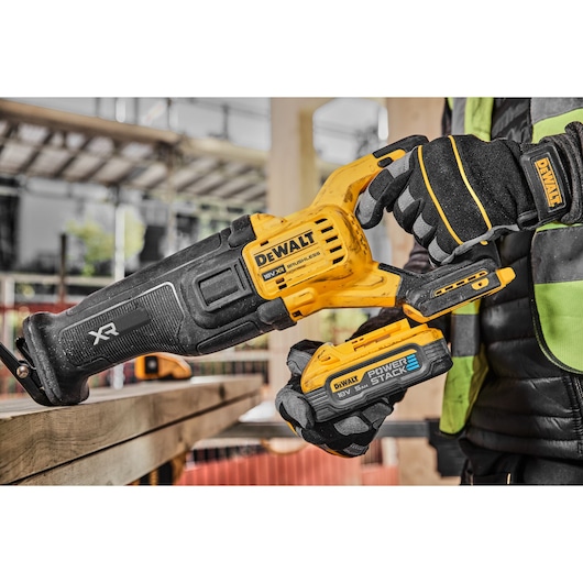 Powerstack battery being connected to a 18V XR Brushless reciprocating saw