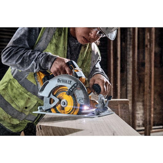 18V XR Brushless Circular Saw cutting wood on a work site