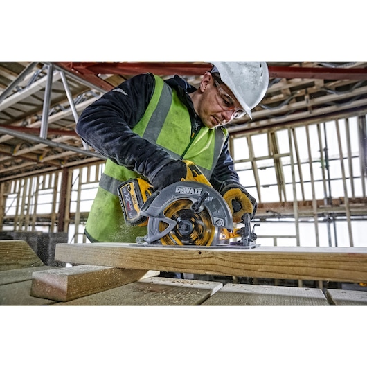 FLEXVOLT brushless cordless circular saw with brake kit being used by person on wood.
