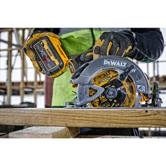 FLEXVOLT brushless cordless circular saw with brake kit being used by person on wood.