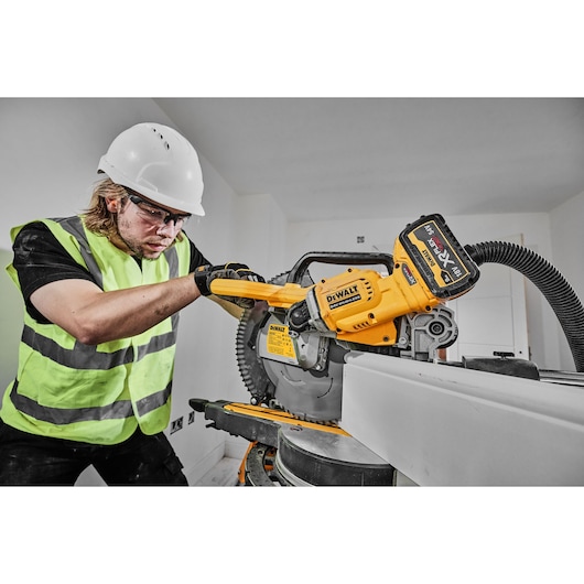 54v XR FLEXVOLT 305mm Mitre Saw close up right side view cutting skirting board