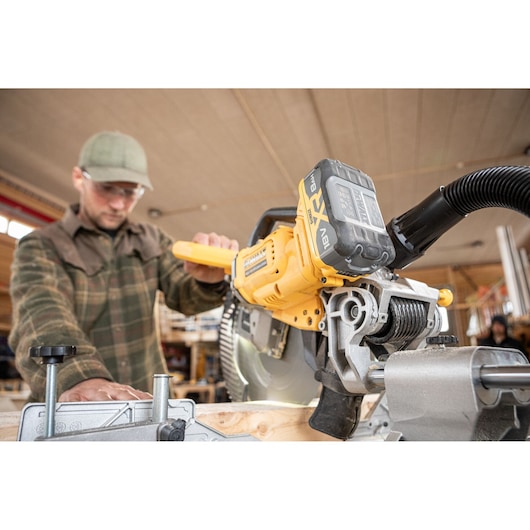 The DEWALT 18V XR 305mm Slide Mitre Saw being used by carpenter in wood shop