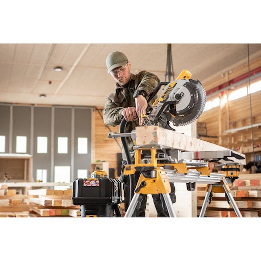 The DEWALT 18V XR 305mm Slide Mitre Saw being used by carpenter in wood shop