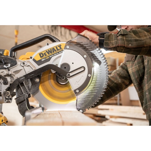 The DEWALT 18V XR 305mm Slide Mitre Saw being used by carpenter in wood shop