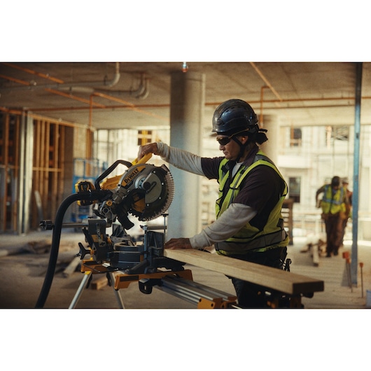 DEWALT Equity photography: Construction worker on site with DEWALT mitre saw