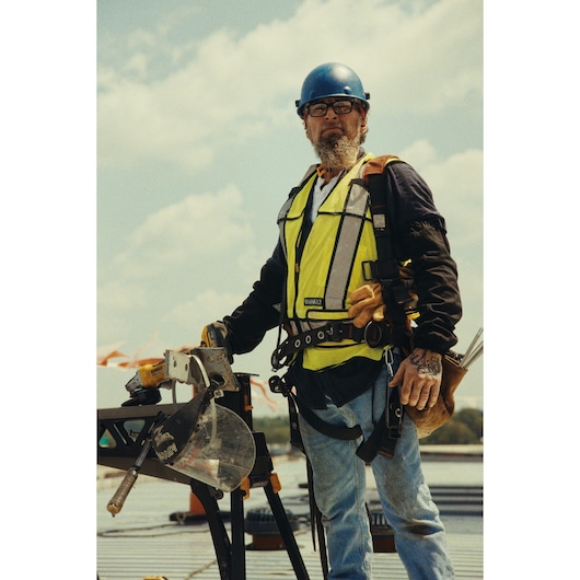 DEWALT Equity photography: Construction worker on site with DEWALT mitre saw