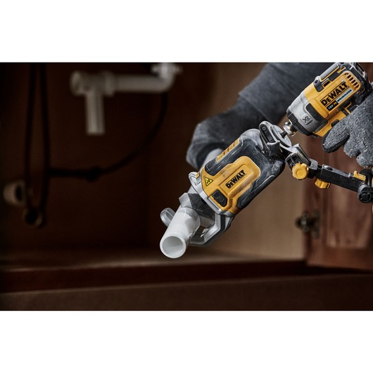 Impact Connect PVC/PEX pipe cutter attachment on Impact Driver close up cutting PVC pipe