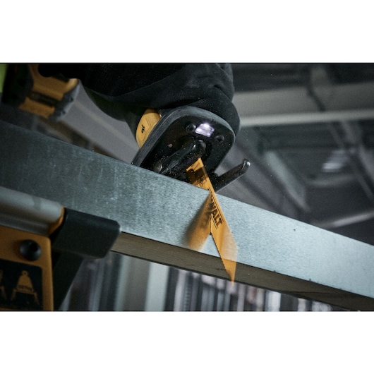 Close up of a reciprocating saw blade fast cutting metal