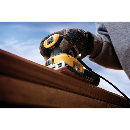 One quarter inch sheet palm grip sander in action on wood.