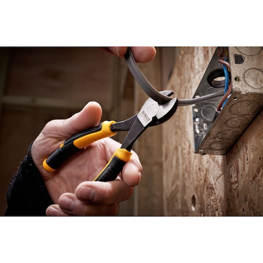DEWALT LH Diag plier 160mm being used to cut cables