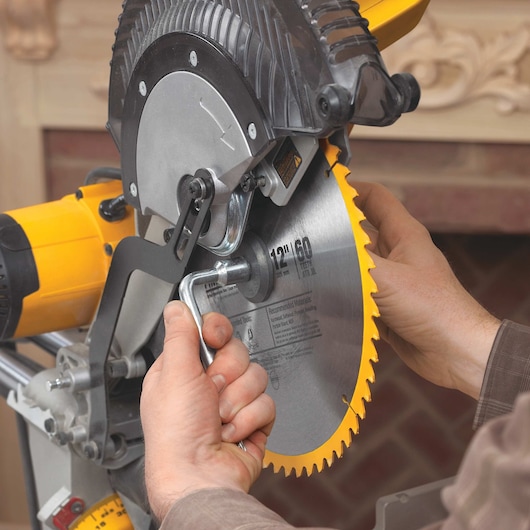 Double bevel sliding compound miter saw blade being adjusted.