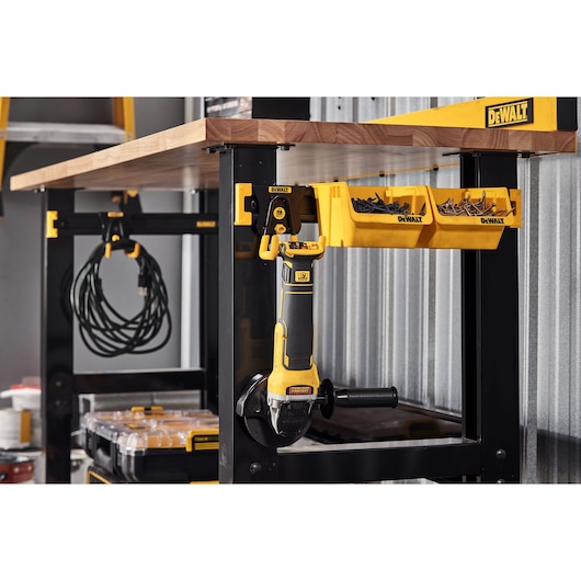 A DEWALT Power Tool and Acessories Hanging on a DEWALT Work Bench