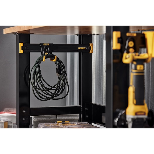 A DEWALT Power Tool and Acessories Hanging on a DEWALT Work Bench